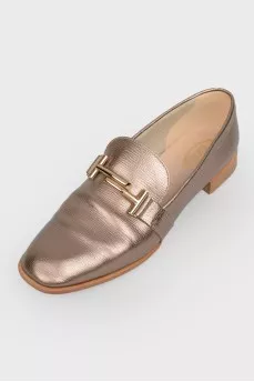 Gold colored loafers