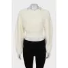 Knitted sweater with a figured collar
