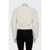 Knitted sweater with a figured collar