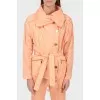 A peach short cloak with an asymmetric fastener on buttons