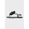 Black sandals decorated with a flower