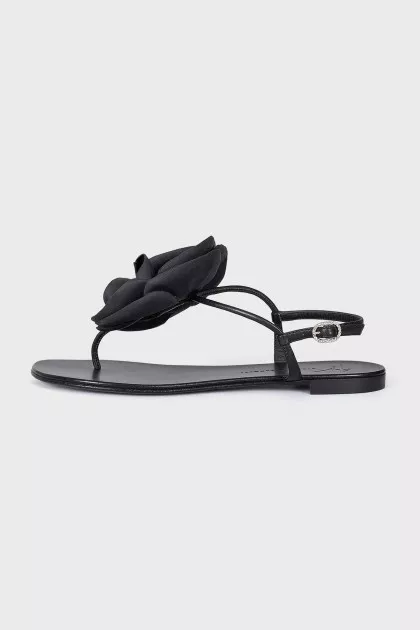 Black sandals decorated with a flower