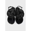 Black sandals decorated with a flower