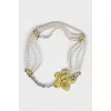 The beaded belt is decorated with a flower