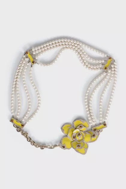 The beaded belt is decorated with a flower