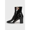 Patent leather ankle boots with signature decor