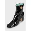 Patent leather ankle boots with signature decor