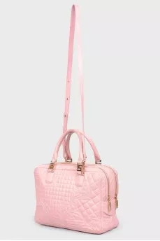 The bag is quilted with golden fittings
