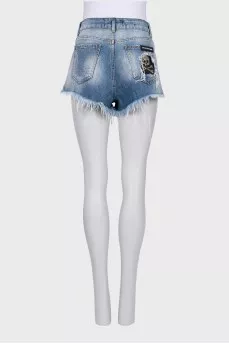 Denim shorts with decorated pocket
