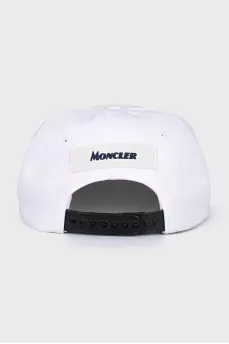 White cap decorated with a patch