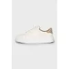 White sneakers with branded logo on the back