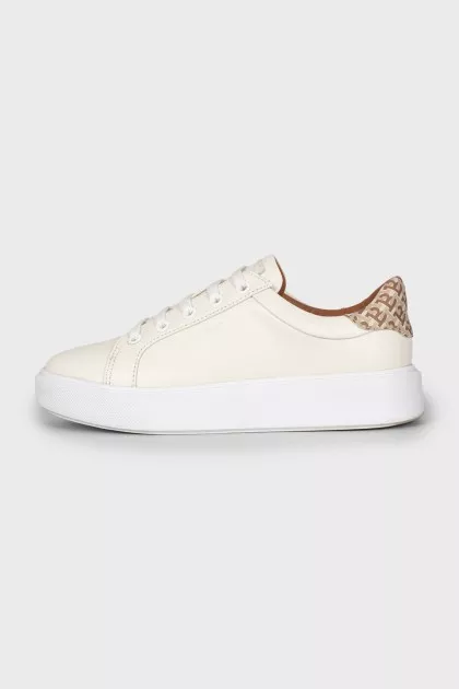 White sneakers with branded logo on the back