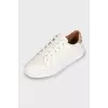 White sneakers with branded logo on the back