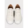 White sneakers with branded logo on the back