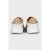 White sneakers with branded logo on the back