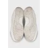 White sneakers with branded logo on the back