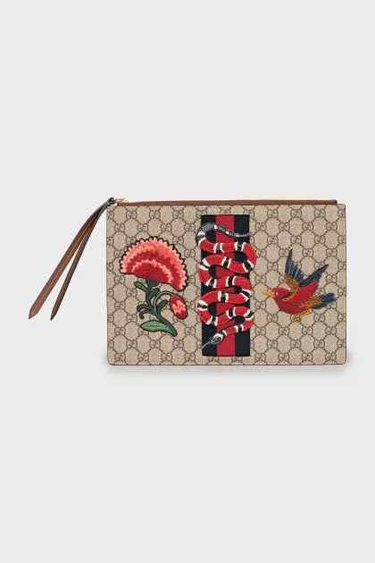 Leather and canvas clutch decorated with patches