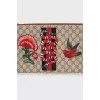 Leather and canvas clutch decorated with patches
