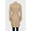 Beige trench coat with branded buttons