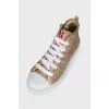 Shiny gold colored sneakers
