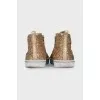 Shiny gold colored sneakers