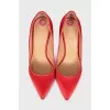 Red satin pumps