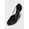 Black patent leather shoes with a figured heel