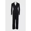 A suit of loose trousers and a fitted blazer