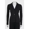 A suit of loose trousers and a fitted blazer