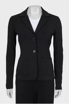 A suit of loose trousers and a fitted blazer