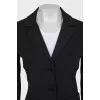 A suit of loose trousers and a fitted blazer