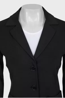 A suit of loose trousers and a fitted blazer