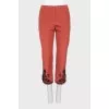 Red trousers with embroidery