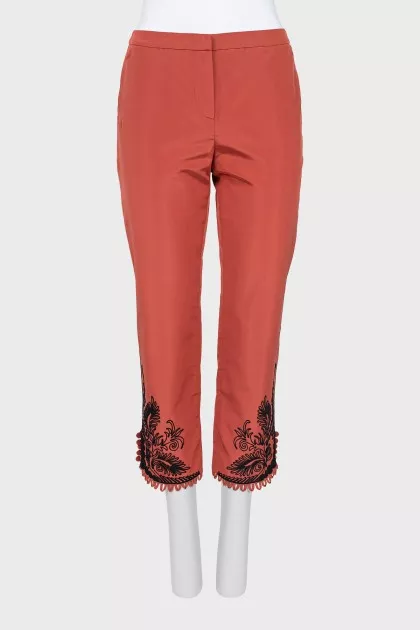 Red trousers with embroidery