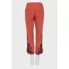 Red trousers with embroidery