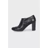 Ankle boots decorated with leather straps