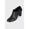 Ankle boots decorated with leather straps