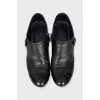 Ankle boots decorated with leather straps