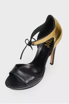 Sandals with a closed golden heel