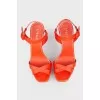Orange sandals on a white platform