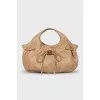 Bag decorated with a golden bow