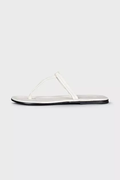 White leather flip flops with tag