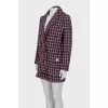 Suit consisting of a jacket with pockets and shorts