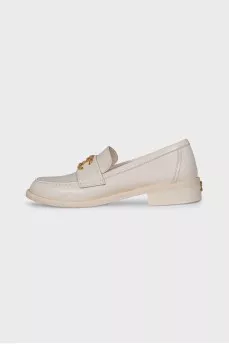 Beige loafers with metal logo