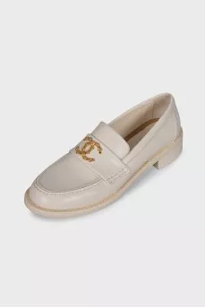 Beige loafers with metal logo