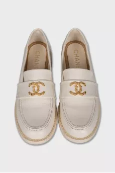Beige loafers with metal logo