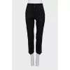 Black trousers with arrows and tag