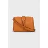 Orange leather bag with tag