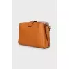 Orange leather bag with tag