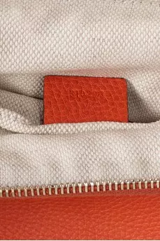 Orange leather clutch
